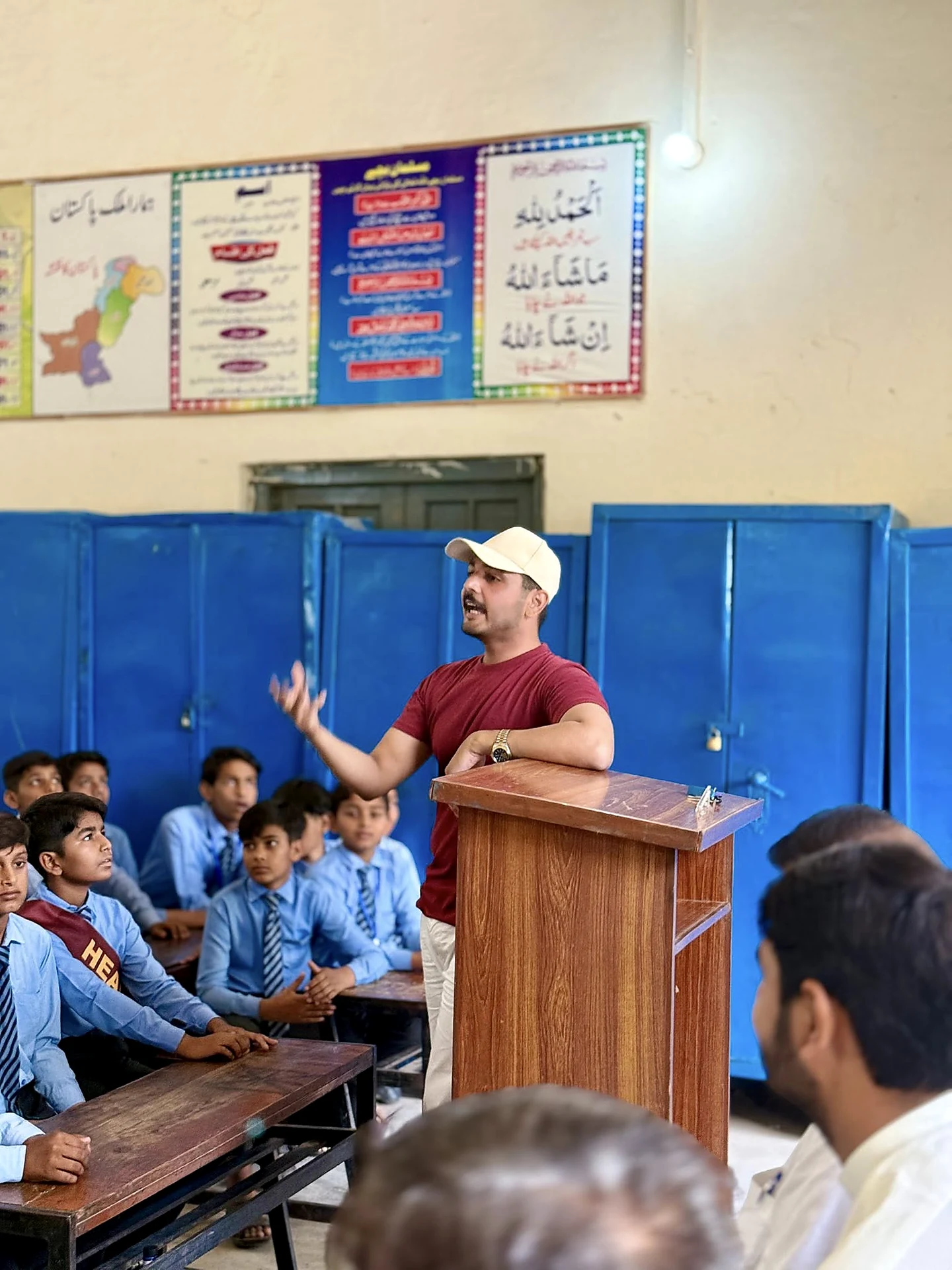 Gohar Rehman Rajput speaking to students at a school podium